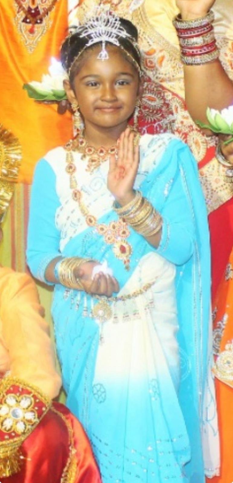 Mother Lakshmi 3 Lilly in blue and white cultural dress during childhood.